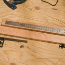 Measure the distance between both lines on the upright supports.